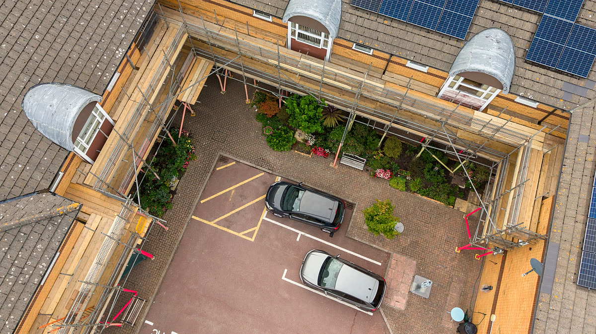 Overhead view of a courtyard with BSL scaffold boarded out around all three elevations