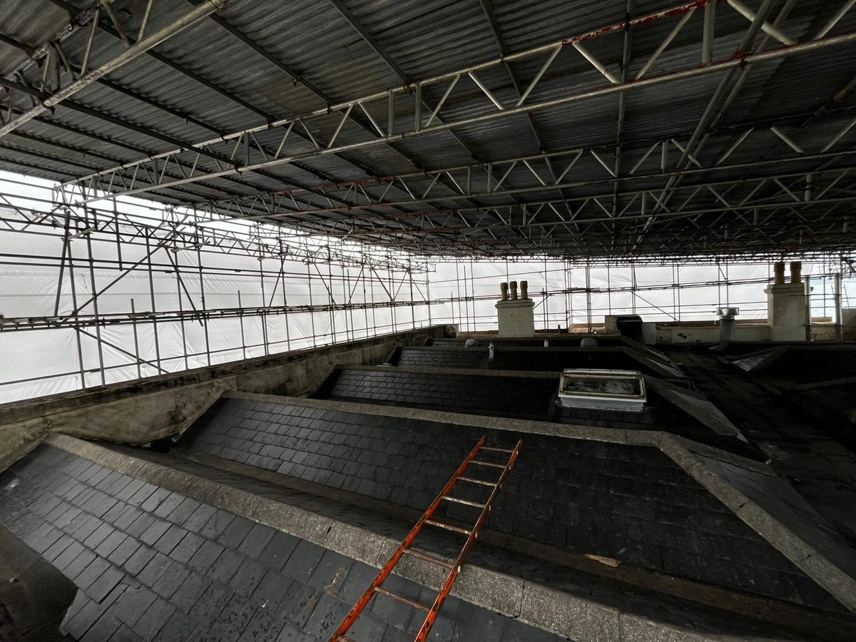 Beneath BSL's temporary roof at Great Salterns House: trussed beams and sheeting spanning the slate roof under repair