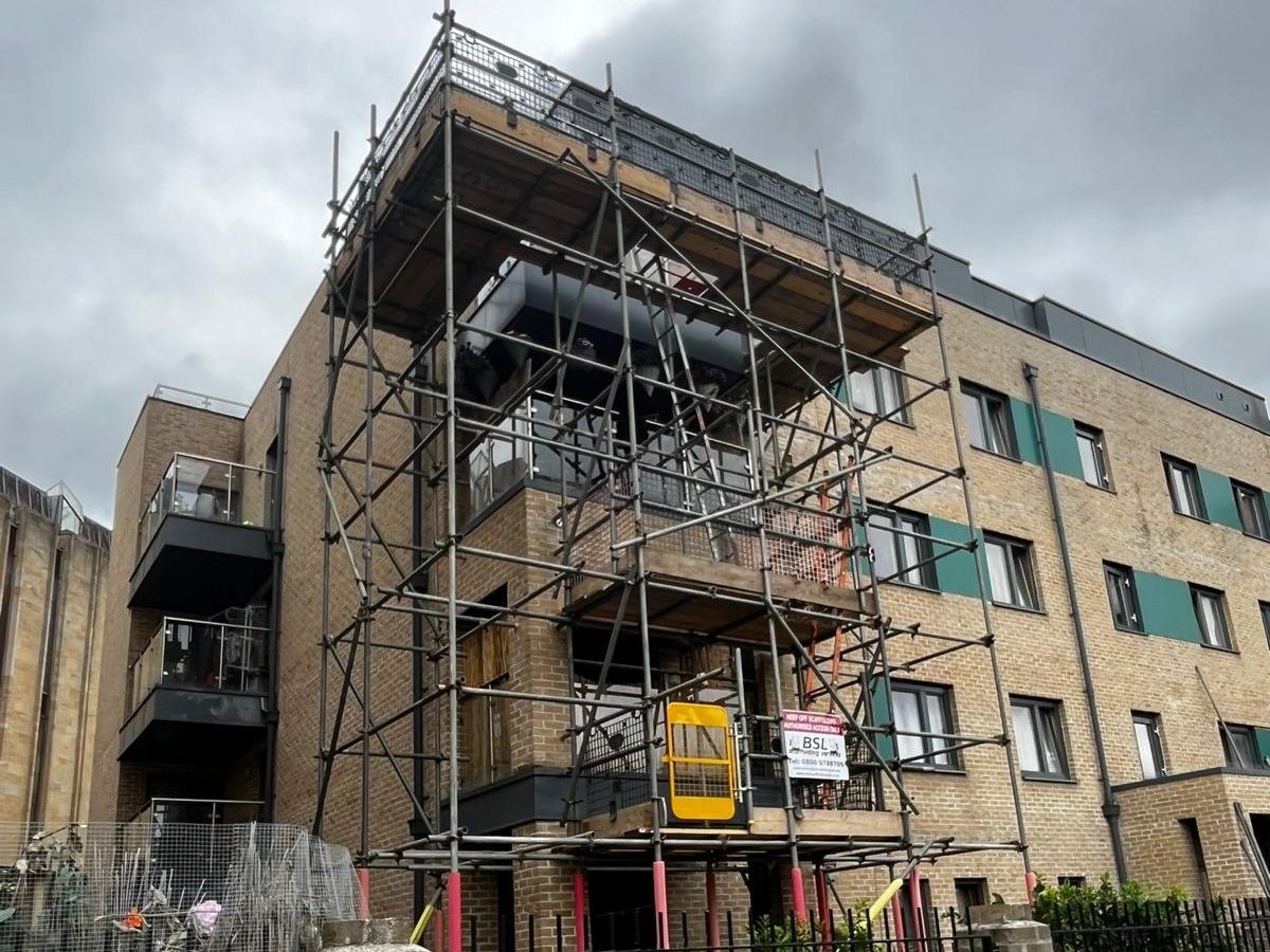 BSL scaffold built up the balcony stack of a block of flats on Thames Street, Oxford, with a safety gate at the working lift